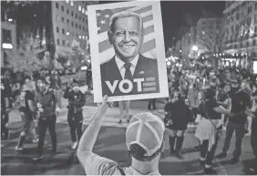  ?? JACK GRUBER/USA TODAY ?? People gather in Washington, D.C., along Black Lives Matter Plaza on Saturday to celebrate President-elect Joe Biden’s victory.