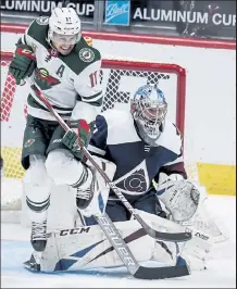  ?? Aaron Ontiveroz / The Denver Post ?? Zach Parise (11) of the Minnesota Wild and Philipp Grubauer (31) of the Colorado Avalanche brace for a shot during the second period on Feb. 2.