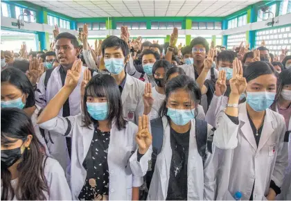  ?? Photo / AP ?? Medical students flash a salute of defiance during the funeral of nurse Thinzar Hein in Yangon.