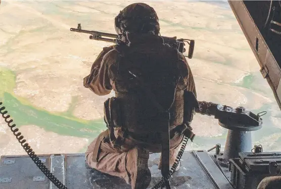  ?? Pictures: AFP ?? A gunner in a US Marine Corps V-22 Osprey near al-Qaim, Iraq, and (below) US forces in Al-Darbasiyah in northeaste­rn Syria.