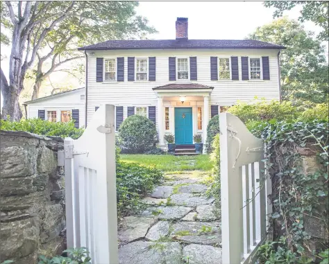  ?? Michelle& Company ?? The circa 1800 colonial at 43 Red Coat Road in Westport features white columns that frame the signature turquoise front door.