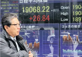  ??  ?? An electronic stock indicator in Tokyo yesterday. Shares were modestly higher in Asia after Wall Street steadied overnight. Investors are awaiting a vote in the US Congress on health-care legislatio­n.