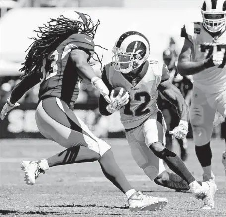  ?? Gary Coronado Los Angeles Times ?? BRANDIN COOKS of the Rams tries to dodge Cardinals defensive back Tre Boston during Sunday’s game. Cooks, who was acquired from the New England Patriots in a deal that cost the Rams a first-round draft pick, had a team-best seven receptions for 159 yards.