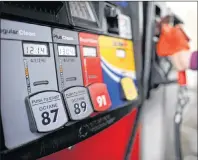  ?? CP PHOTO ?? A motorist reaches for the pump at a gas station in Toronto on Feb. 24, 2011.