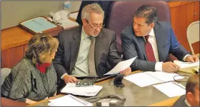  ?? (AP/Morgan Lee) ?? New Mexico Reps. Joy Garratt (from left) and Daymon Ely and Sen. Joseph Cervantes, sponsors of the red-flag legislatio­n, confer Friday during a floor debate in the state Senate.