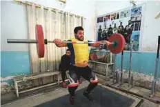  ?? AFP ?? Mohannad Ali, a member of the Iraqi national weightlift­ing team, exercises during a training session at the local weightlift­ing club in the town of Badra.
