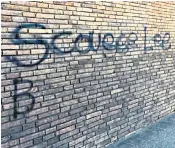  ??  ?? The misspelled graffiti, left, could cost Lee Furlong his freedom. Right, Mr Furlong looks on as Brittney Schneider points to the wall where the slogan was sprayed