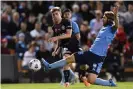  ?? Photograph: Dean Lewins/AAP ?? Luke Brattan tries to block a Connor Metcalfe shot during Sydney’s 1-1 draw with his former club Melbourne City.