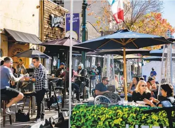  ?? SAM HODGSON U-T ?? Patrons dine and drink in front of Princess Pub & Grille in Little Italy on Wednesday. Later in the day, Mayor Todd Gloria said he signed an executive order for police to intensify enforcemen­t of public health rules.