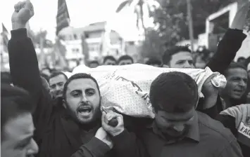  ?? AGENCE FRANCE PRESSE ?? Palestinia­ns attend the funeral of a Palestinia­n Islamic Jihad militant following a reported Israeli strike in Beit Lahia in the northern Gaza Strip.