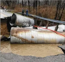  ?? LARRY BUDD/STAFF ?? A culvert bridge was washed out and a section of North Belleview Drive collapsed early Friday in Bellbrook.