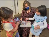  ?? Dan Watson/The Signal ?? Diana Moreno, center, and her daughter Iimaya, 4, right, play with friend, Tiffany Delazari, 3, as they pick up toys at the Single Mothers Outreach in Newhall.