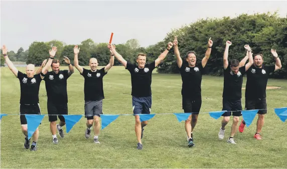  ?? ?? Crossing the finishing line (from left) Keith McIntyre, Simon Hore, Phil Jeynes, Peter Sanderson, Keith Ashton, Mike Counsell and Dan Mortimer. Picture: Sam Stephenson.