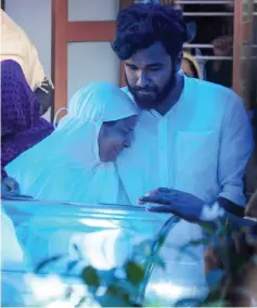  ??  ?? The mother Razia (left) and brother Asif Ali of Ansi Alibava mourn over her body in Kodungallu­r in Trissur district in the Indian state of Kerala. — AFP photo