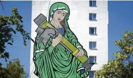  ?? EFREM LUKATSKY/AP ?? A mural depicts an image known as “Saint Javelina” — Virgin Mary cradling a U.S.-made FGM-148 anti-tank weapon Javelin — on a wall in Kyiv, Ukraine, Monday. These missiles are among the arms being sent by Western allies to Ukrainian forces.