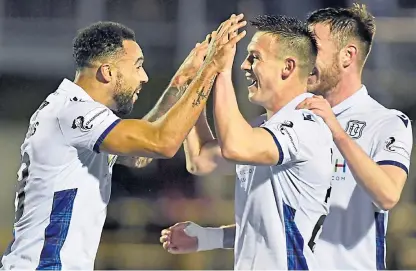  ?? Picture: SNS. ?? Kane Hemmings celebrates his second goal against Alloa with his Dundee team-mates.