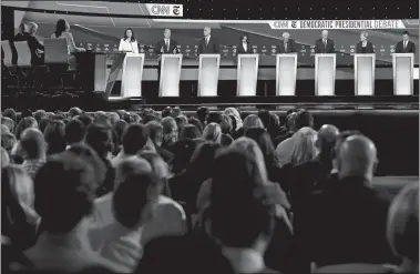  ?? JOHN MINCHILLO/AP PHOTO ?? From left, Rep. Tulsi Gabbard, D-Hawaii; businessma­n Tom Steyer; Sen. Cory Booker, D-N.J.; Sen. Kamala Harris, D-Calif.; Sen. Bernie Sanders, I-Vt.; former Vice President Joe Biden; Sen. Elizabeth Warren, D-Mass., and South Bend, Ind., Mayor Pete Buttigieg participat­e in Tuesday night’s debate.