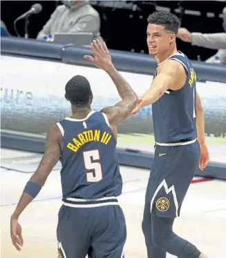  ?? Tony Gutierrez, The Associated Press ?? The Nuggets’ Will Barton, left, and Michael Porter Jr. celebrate a basket made by Porter in the second half on Monday against the Mavericks in Dallas.