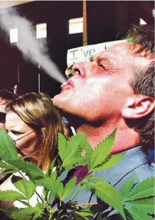  ?? KEVIN FRAYER / CP FILE PHOTO ?? Marc Emery, a.k.a. the Prince of Pot, indulges at a pro-legalizati­on rally outside Toronto police headquarte­rs in 2003. He’s on bail, facing possible extraditio­n to the U.S. for selling marijuana seeds.