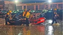  ?? PITTSBURGH PUBLIC SAFETY VIA AP ?? Pittsburgh area water rescue team evacuate a woman Thursday who was trapped in a sinking car along a section of Route 51 east of the city in Pittsburg.