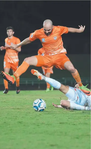  ?? Picture: JUSTIN BRIERTY ?? COSTLY LOSS: Cairns FC defender Shaun Owens flies high over his Lions FC opponent as the men in orange suffer a 6-0 rout at Barlow Park.