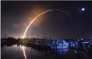  ?? MALCOLM DENEMARK — FLORIDA TODAY VIA AP ?? NASA’s new moon rocket lifts off from the Kennedy Space Center in Cape Canaveral, Wednesday morning, as seen a Harbor town Marina.