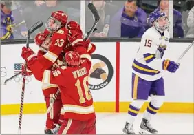  ?? Michael Dwyer / Associated Press ?? Denver's Massimo Rizzo (13) celebrates his goal with teammates as Minnesota State's Julian Napravnik reacts Saturday.