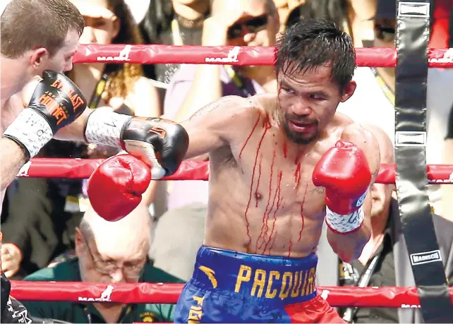  ?? AP FOTO ?? DOWN AND DIRTY. Blood drips to Manny Pacquiao’s body from a cut opened by an accidental head butt. Pacquiao, the overwhelmi­ng favorite, lost by unanimous decision to Jeff Horn.