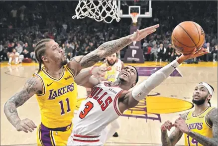  ?? Photograph­s by Mark J. Terrill Associated Press ?? MICHAEL BEASLEY and the LeBron James-less Lakers turned away the challenge by Shaquille Harrison and a 10-win Bulls team.