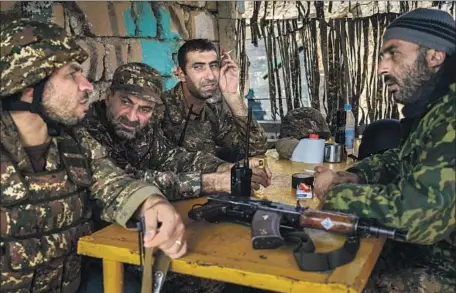  ?? Photog r aphs by Marcus Yam Los Angeles Times ?? SOLDIERS take a break at an outpost near Martakert, in Nagorno- Karabakh, a territory controlled by Armenia- backed forces but internatio­nally recognized as belonging to Azerbaijan. Armenia’s forces f ind themselves up against Azerbaijan’s f leet of high- tech drones.