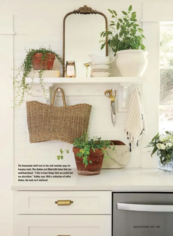  ?? ?? The homemade shelf next to the sink includes pegs for hanging tools. The shelves are filled with items that are multifunct­ional. “I like to have things that are useful but are also décor,” Ashley says. With a collection of white dishes, the look isn’t cluttered.