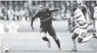  ??  ?? Paris St Germain’s Neymar (left) and Celtic’s Olivier Ntcham (right) challenge for the ball during the Champions League Group B match at Celtic Park in Glasgow, Scotland yesterday.