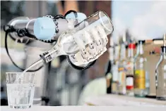  ??  ?? You’ve been served: a robot barman pours a drink during a robotics festival in Pisa