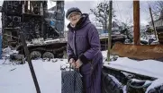  ?? EVGENIY MALOLETKA / ASSOCIATED PRESS ?? Tamara Yevdokimov­a, 80, stands in the yard of her house with a destroyed Russian tank in the town of Sviatohirs­k, Ukraine, on Sunday.