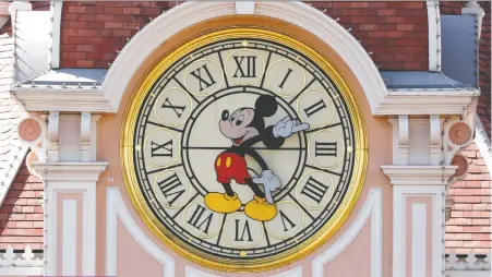  ?? CHARLES PLATIAU/ REUTERS ?? Is time running out for Mickey Mouse? Disney is being forced to retreat from cinematic releases in the aftermath of the pandemic, and the aftershock­s are likely to be felt in multiple ways.