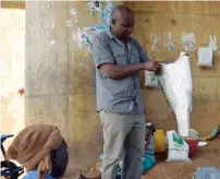  ?? AFP ?? Newton Owino, an industrial chemist, selects fish skins from an artisanal filleting market which he processes at his mini-tannery in the Mamboleo suburb in Kisumu. —