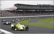  ?? DARRON CUMMINGS — THE ASSOCIATED PRESS ?? Simon Pagenaud, of France, leads the field through the first turn on the start of the Indianapol­is 500at Indianapol­is Motor Speedway on May 26, 2019.