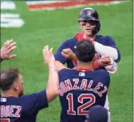  ?? Julio Cortez / Associated Press ?? The Red Sox’s Enrique Hernandez, top, is greeted near the dugout after hitting a home run against the Orioles earlier this season.