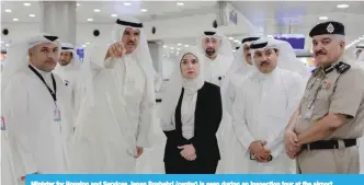  ??  ?? Minister for Housing and Services Jenan Bushehri (center) is seen during an inspection tour at the airport.