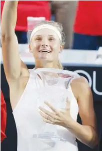  ?? Agence France-presse ?? Novak Djokovic reacts after defeating Borna Coric (unseen) in their singles final match at the Shanghai Masters on Sunday. Right: Dayana Yastremska poses with the trophy after winning the singles final match at the Hong Kong Open on Sunday.