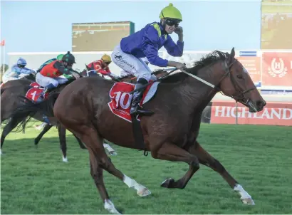  ?? Picture: Wayne Marks ?? EASING UP. Rainbow Bridge cruises past the post in the Grade 3 Winter Guineas and jockey Richard Fourie has time to celebrate.