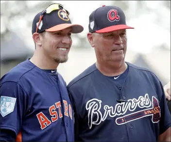  ?? The Associated Press file ?? “He’s the same guy every day when you’re in the clubhouse with him,” Astros hitting coach Troy Snitker, left, said of his father, Braves manager Brian Snitker.