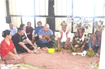  ??  ?? (From right) Sigai, former councillor of Kanowit District Council Kujat Dudang, Ugap, Allan and Daniel perform a ‘miring’ ceremony before the skulls are relocated to a hut outside the fort’s building.