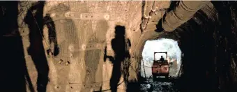  ??  ?? SHADOWS of mining personnel 990m below the surface are cast on a far wall as a miner works his machine in the background at the Stillwater Mine Complex.The Stillwater mine has about 200 workers at the mine. | Supplied