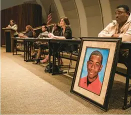  ?? LOREN ELLIOTT/AP ?? Andrew Joseph Jr. sits behind a picture of his deceased son, Andrew Joseph III, at a 2015 Black Lives Matter forum at John Germany Library in Tampa.