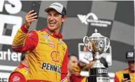  ?? JEFF ROBERSON / ASSOCIATED PRESS ?? Joey Logano celebrates after winning a NASCAR Cup Series auto race at World Wide Technology Raceway, Sunday in Madison, Ill.