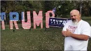  ?? JOHN SEEWER — THE ASSOCIATED PRESS ?? Mike Devore poses Oct. 14 near an 8-foot tall sign he made in his yard to show his support for President Donald Trump in Wayne. Devore lives in Wood County, an election bellwether that only once since 1964 has not picked the presidenti­al winner.