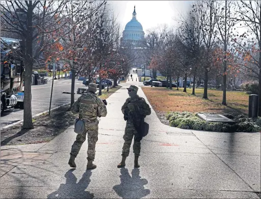  ??  ?? The US Capitol building in Washington DC seen through mesh fencing yesterday as security tightens ahead of Wednesday’s inaugurati­on