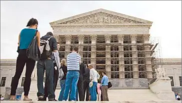  ?? Evan Vucci ?? VISITORS wait in line outside the Supreme Court. In an early case, usually business-friendly conservati­ve justices signaled they might allow a class-action suit over a bank’s role in R. Allen Stanford’s Ponzi scheme.