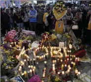  ?? MICHAEL OWEN BAKER - THE ASSOCIATED PRESS ?? People gather at a memorial near Staples Center after the death of Laker legend Kobe Bryant Sunday, Jan. 26, 2020, in Los Angeles.